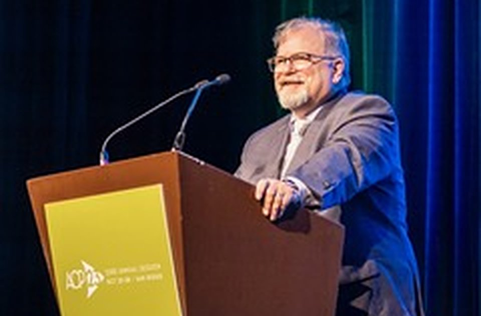 Gerald Thomas Grant speaking at an American College of Prosthodontists lectern